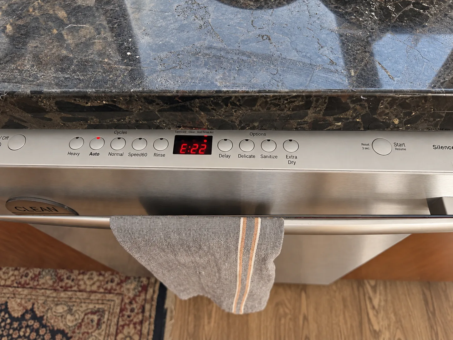 A dishwasher control panel showing error E22